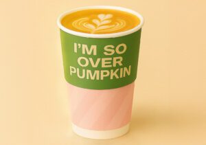 Snowflake Pistachio Spice Latte in branded takeaway cup with autumn leaves